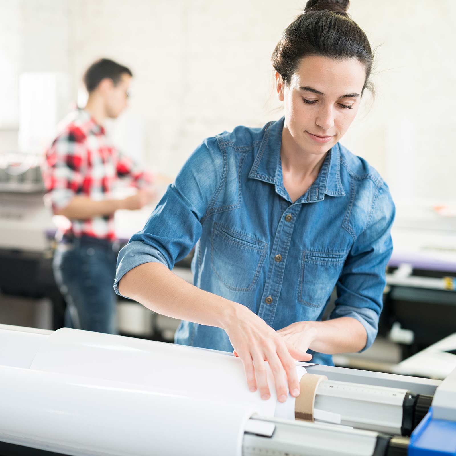 Woman Loading Large Format Printer
